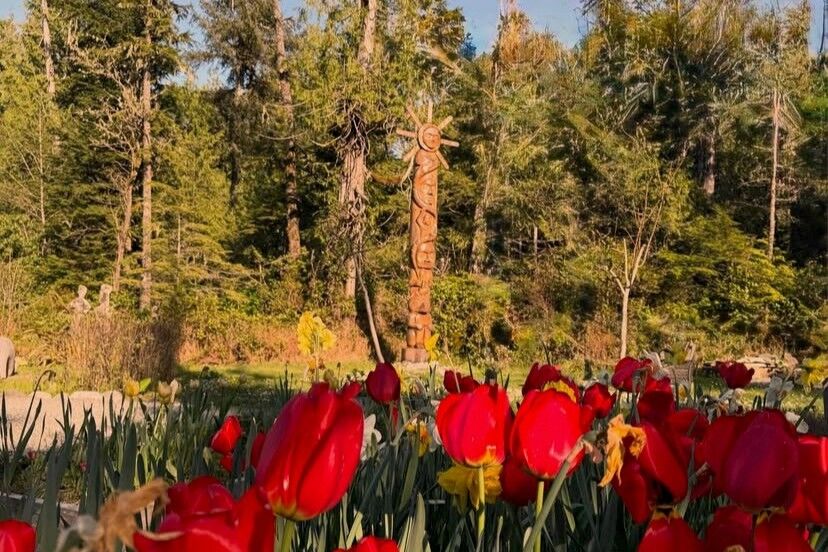 flowers and totem pole at gardens Tofino